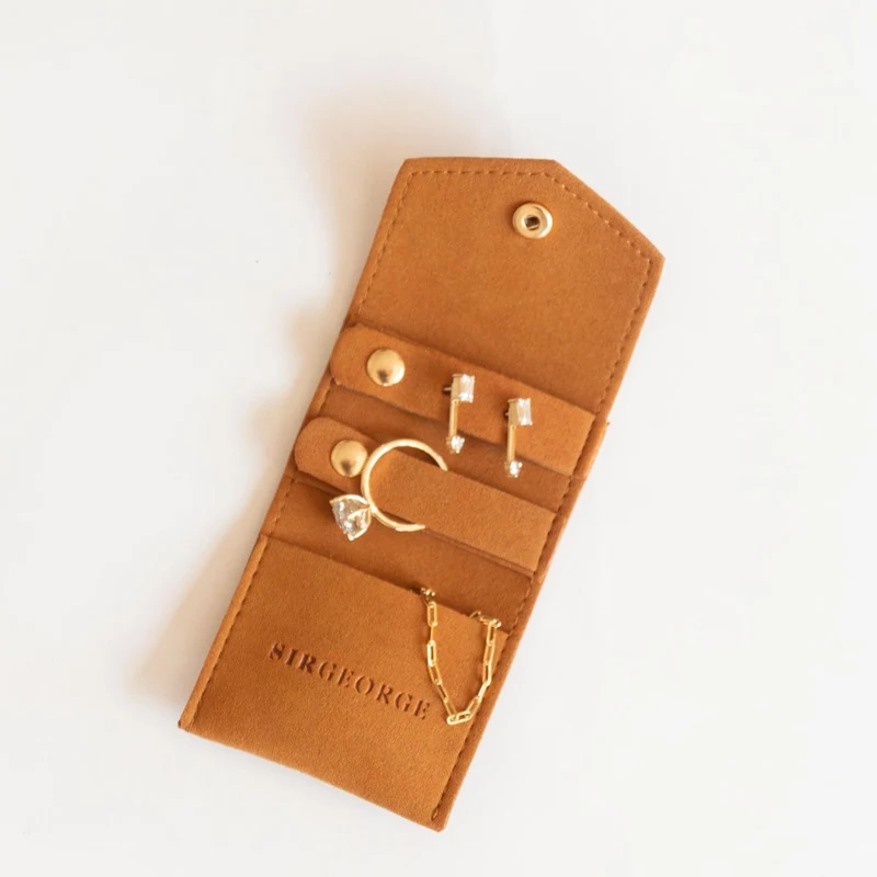 Tan microfiber fold-out multi-slot jewelry travel organizer with debossed logo