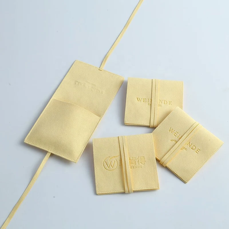 Yellow microfiber drawstring pouches in multiple sizes with debossed logo